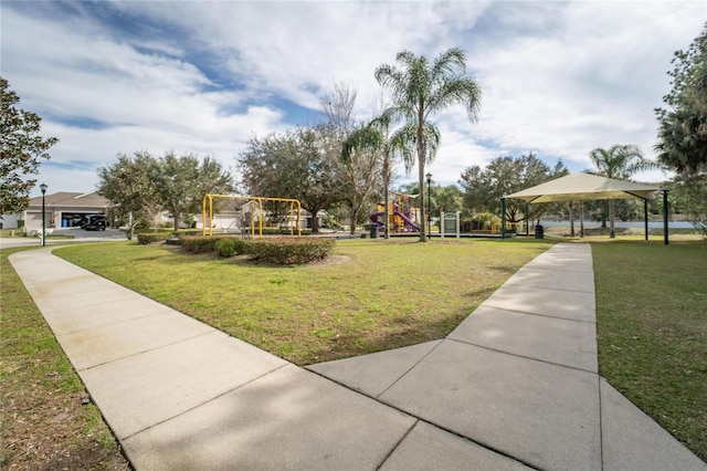 view of property's community featuring a playground, a gazebo, and a yard