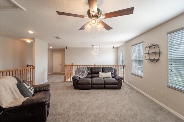 living room featuring ceiling fan and light colored carpet