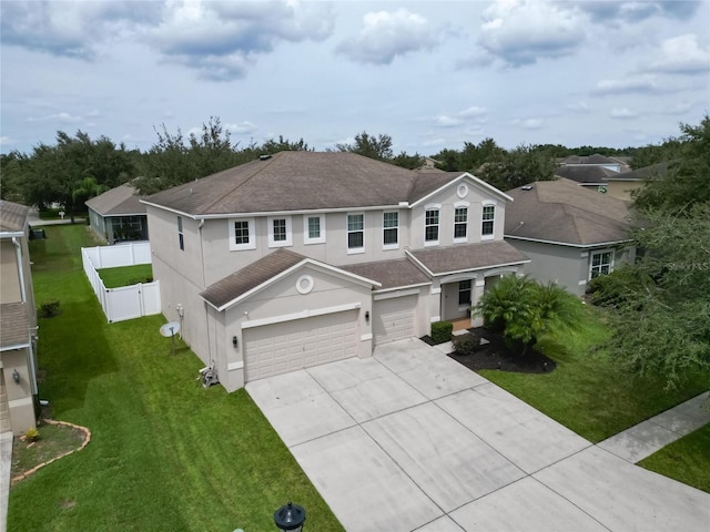 view of front of house with a garage and a front lawn