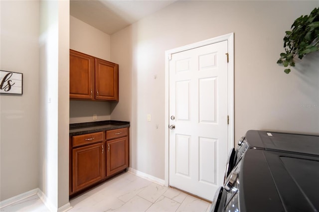 laundry room with cabinets and washer and clothes dryer