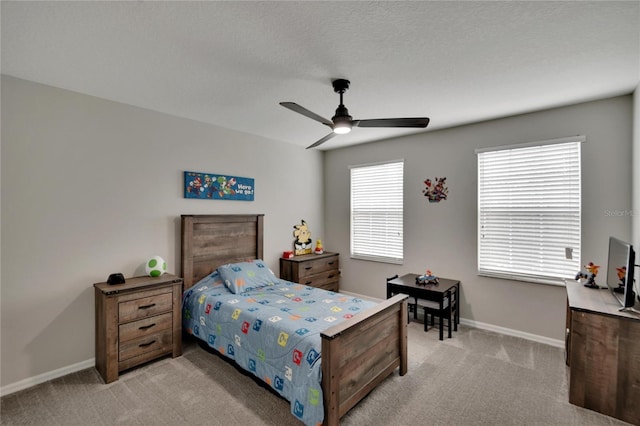 carpeted bedroom with a textured ceiling and ceiling fan