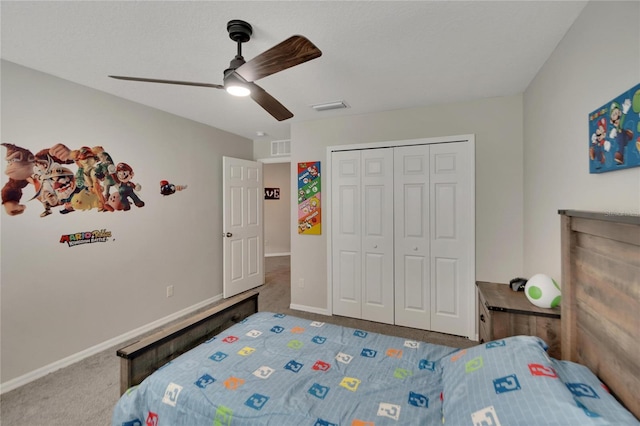 carpeted bedroom featuring ceiling fan and a closet