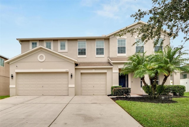 view of front of home featuring a garage and a front lawn