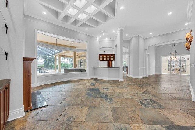 unfurnished living room with crown molding, coffered ceiling, beam ceiling, and a towering ceiling