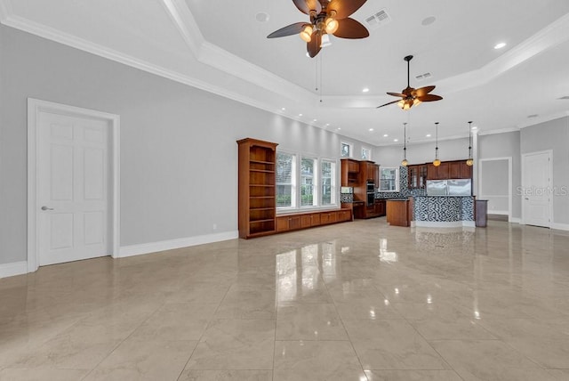 unfurnished living room with ceiling fan, a raised ceiling, and crown molding