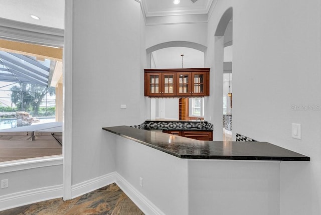 interior space featuring sink, crown molding, and kitchen peninsula