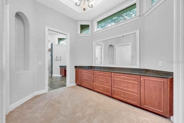 bathroom featuring vanity and a towering ceiling