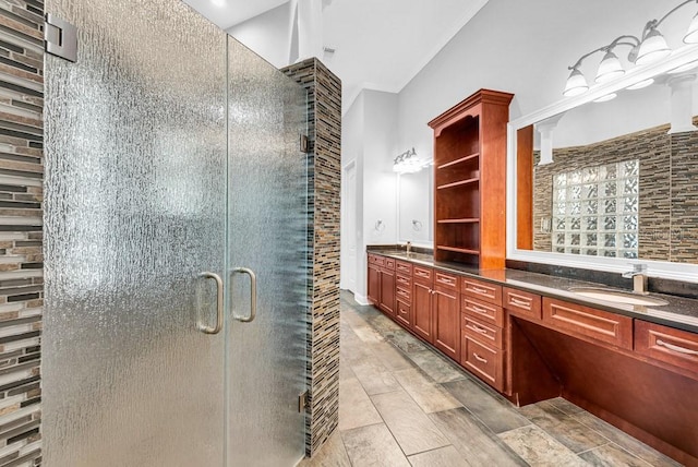 bathroom with vanity and a shower with door