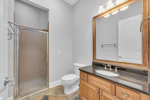 bathroom with vanity, toilet, and an enclosed shower