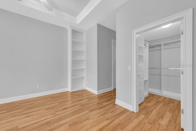 unfurnished bedroom with ceiling fan and light wood-type flooring