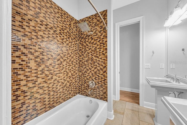 bathroom featuring vanity, tiled shower / bath combo, and tile patterned flooring