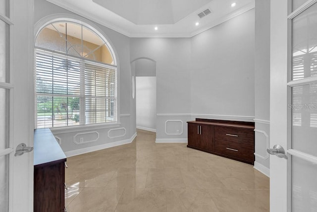 bathroom with ornamental molding and a high ceiling