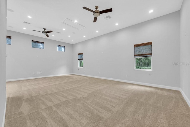 carpeted spare room with ceiling fan