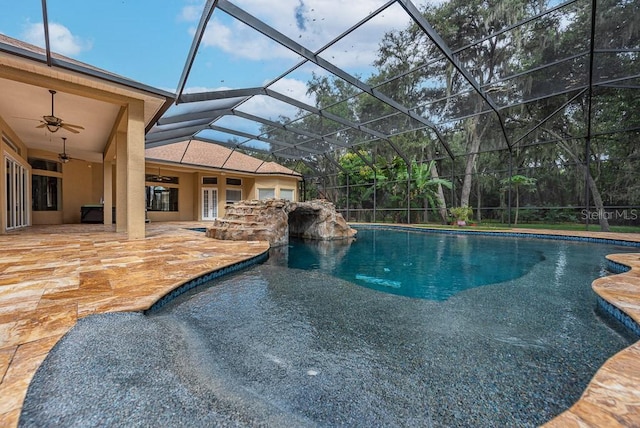 view of swimming pool featuring ceiling fan, glass enclosure, and a patio area