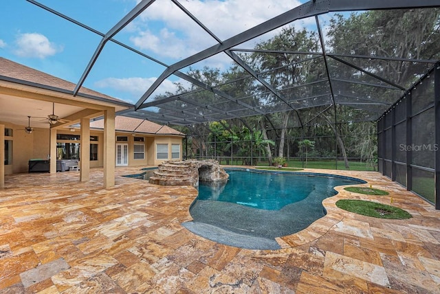 view of swimming pool featuring a lanai, ceiling fan, and a patio area