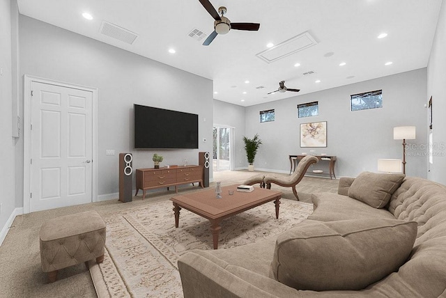 carpeted living room with ceiling fan