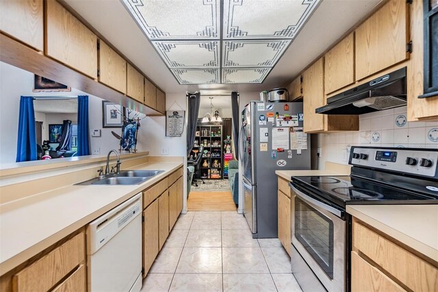 kitchen featuring light tile patterned floors, stainless steel appliances, tasteful backsplash, and sink