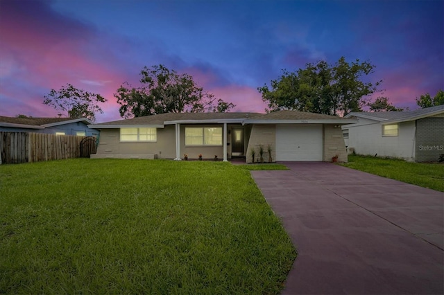 single story home with a yard and a garage