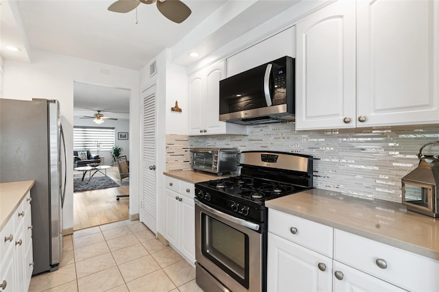 kitchen featuring white cabinetry, ceiling fan, appliances with stainless steel finishes, and light tile patterned floors