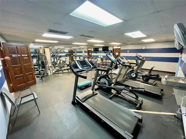 gym featuring a paneled ceiling