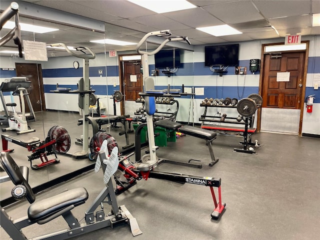 exercise room featuring a paneled ceiling