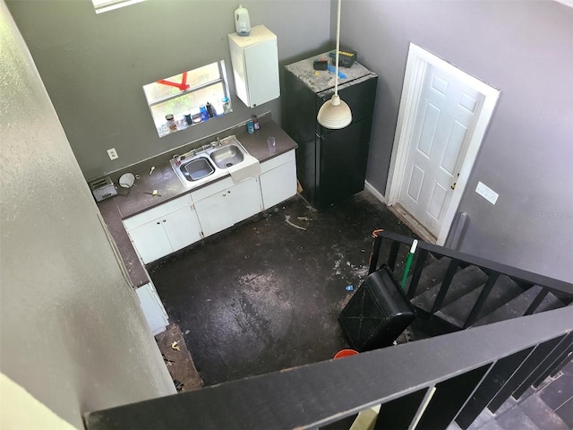 kitchen featuring a sink, white cabinets, and vaulted ceiling