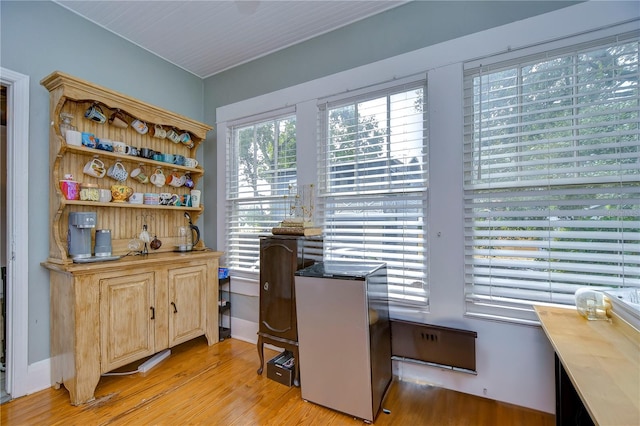 home office with light hardwood / wood-style floors