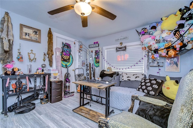 living room with light wood-type flooring and ceiling fan