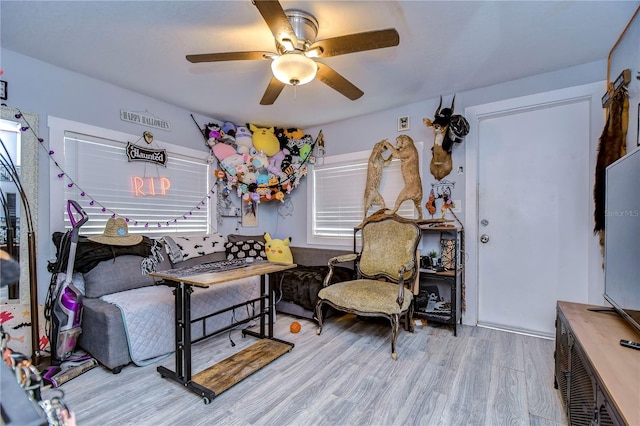 living room featuring light wood-type flooring and ceiling fan