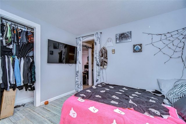 bedroom featuring hardwood / wood-style floors and a closet