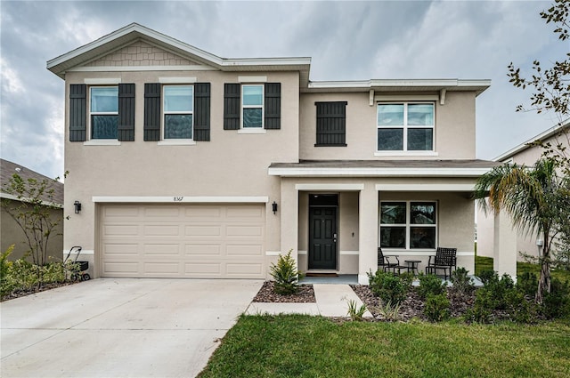 view of front of house featuring a front yard and a garage