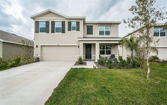 view of front facade featuring a front yard and a garage