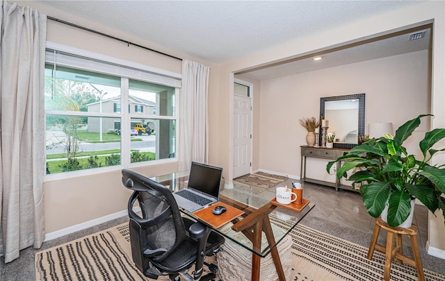 tiled home office with a textured ceiling