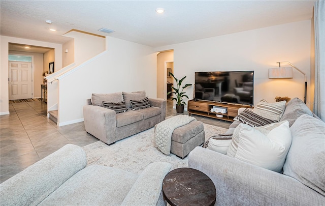 living room with a textured ceiling and tile patterned floors