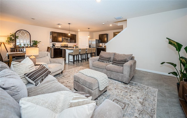 living room featuring a textured ceiling and tile patterned flooring