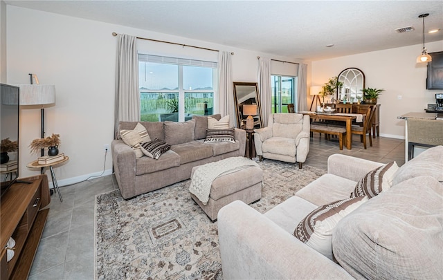 living room with a textured ceiling and tile patterned flooring