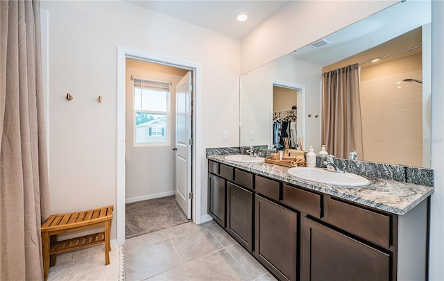 bathroom with vanity, a shower, and tile patterned floors