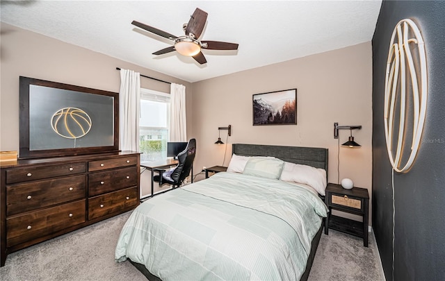 bedroom featuring ceiling fan and light carpet