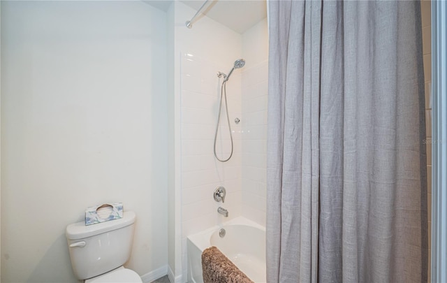 bathroom with shower / bath combo with shower curtain and toilet