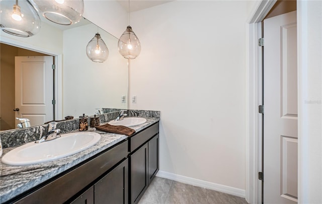 8367 Ender Hills Dr, Wesley Chapel, FL 33545 - bathroom featuring double vanity, tile patterned flooring, and baseboards