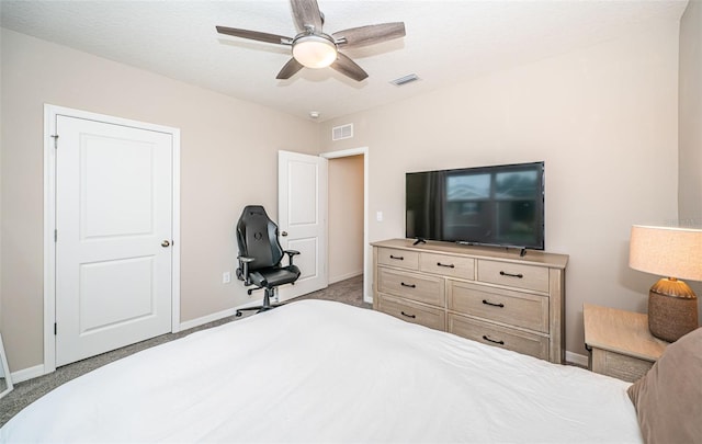 bedroom with ceiling fan, light colored carpet, and a textured ceiling