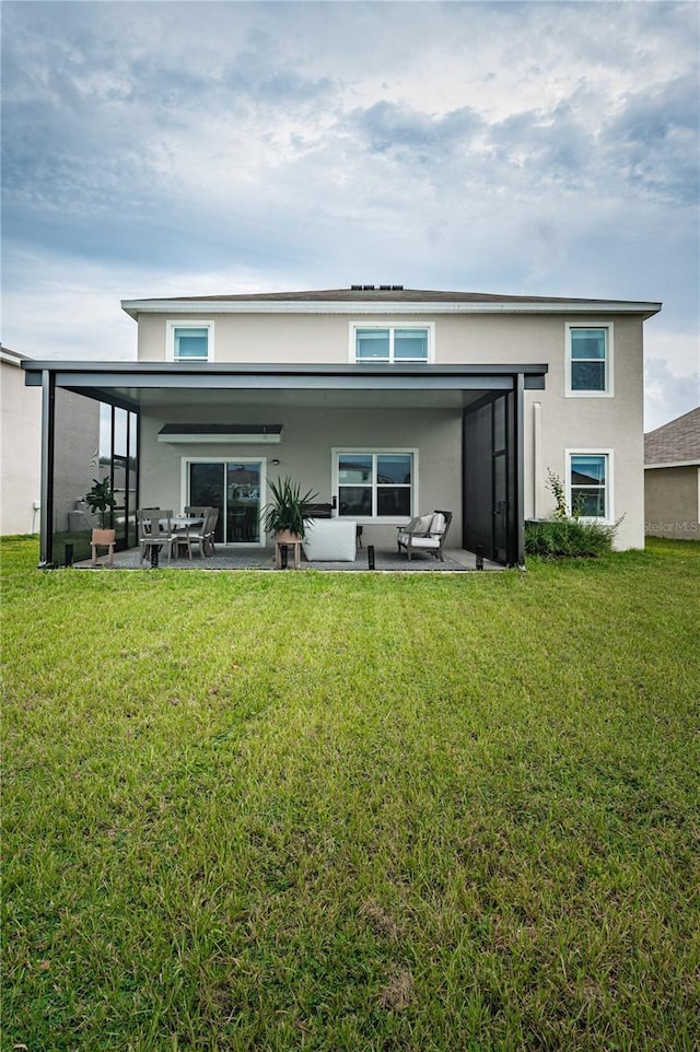 8367 Ender Hills Dr, Wesley Chapel, FL 33545 - back of house featuring stucco siding, a patio, a lawn, and an outdoor hangout area