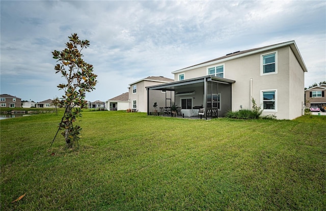 8367 Ender Hills Dr, Wesley Chapel, FL 33545 - rear view of house featuring stucco siding, a sunroom, and a yard
