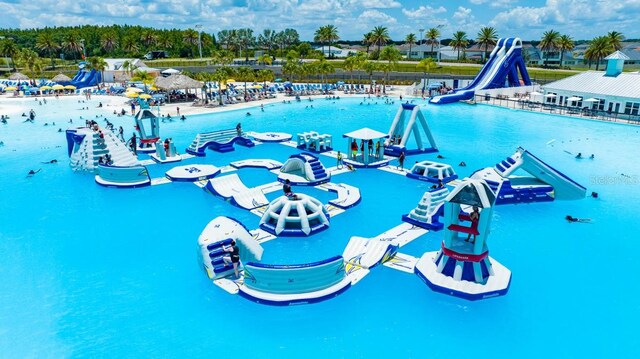 8367 Ender Hills Dr, Wesley Chapel, FL 33545 - community pool with a water slide, a water play area, and fence