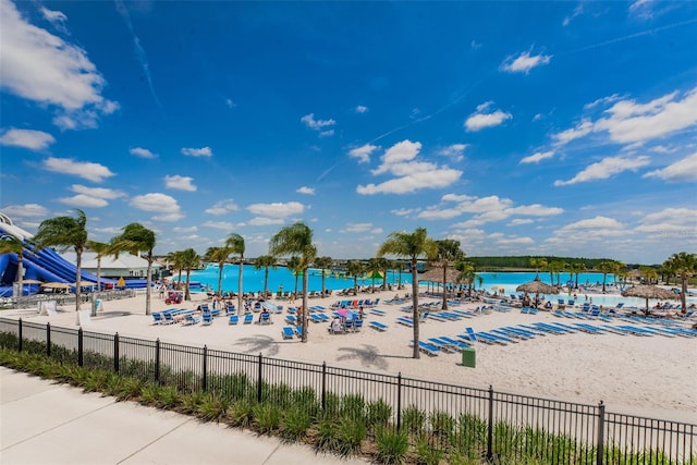 view of pool with a beach view and a water view