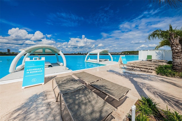 view of pool featuring a water view and a water slide