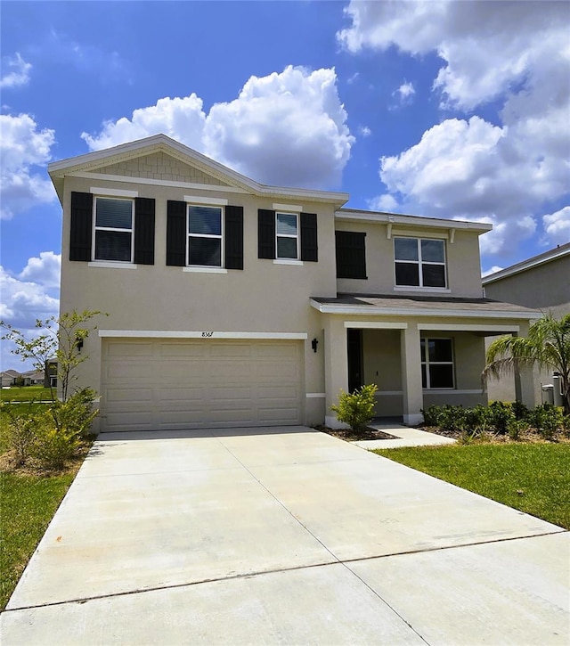 8367 Ender Hills Dr, Wesley Chapel, FL 33545 - view of front of property with a garage, stucco siding, and concrete driveway