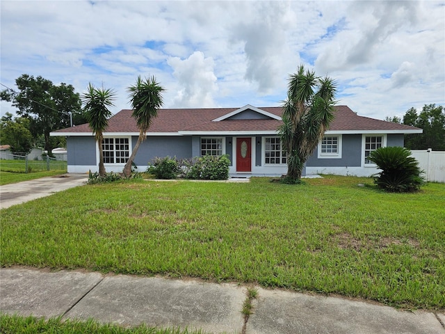 ranch-style home with a front lawn