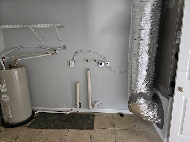 laundry area with hookup for a washing machine, electric dryer hookup, tile patterned floors, and water heater