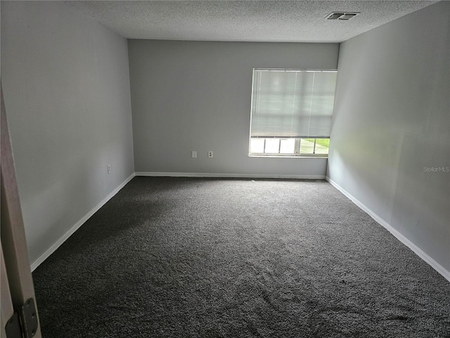 carpeted spare room featuring a textured ceiling